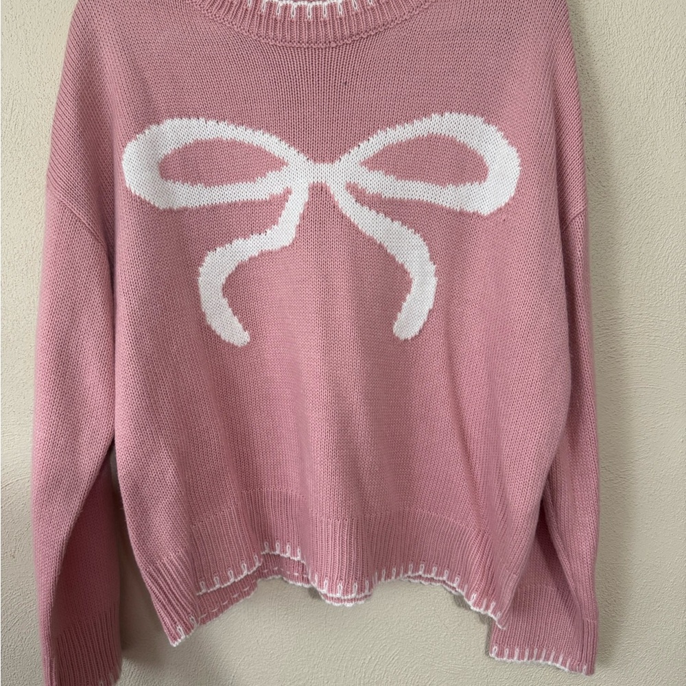 Pink Sweater with White Bow Design